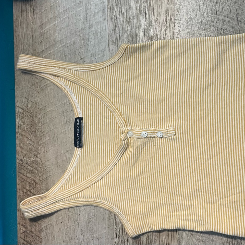 Yellow/white striped Brandy Melville tanktop. It buttons up partially